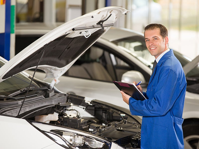 Hyundai service technician looking a Hyundai vehicle's brake pads.